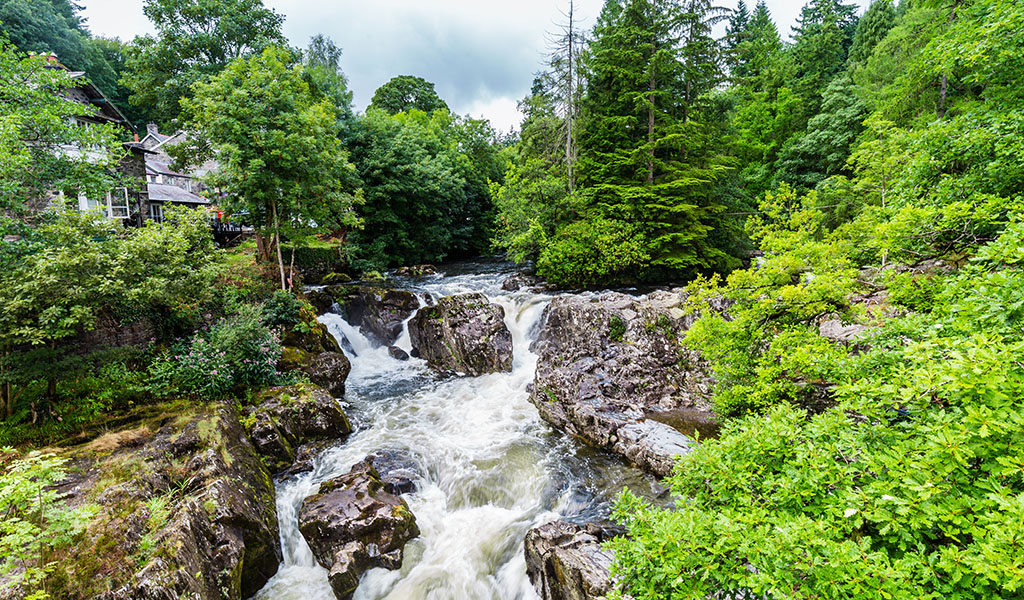 Traditional bridge and rapids of Betws-y-Coed town in Snowdonia National Park in Wales, UK