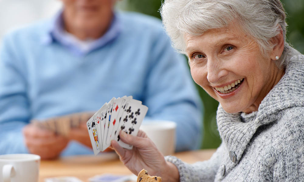Two seniors playing cards together.