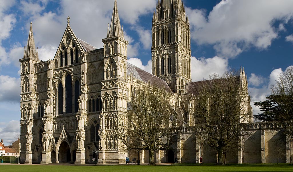View of Salisbury Cathedral in England with blue sky and white clouds