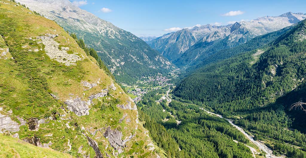 Aerial view of an alpine valley, example of glacial valley. Anzasca Valley,at the foot of Mount Rosa, with the characteristic villages of Macugnaga (Staffa - Pecetto) and Borca, Piedmont, Italy