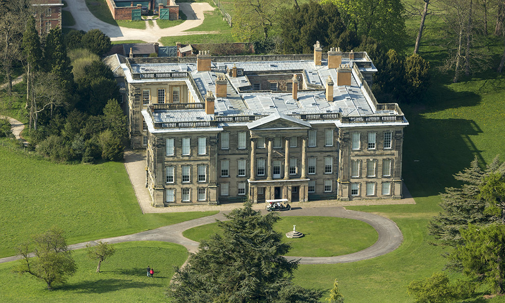 An aerial view of Calke Abbey, Derbyshire. There are beautiful, yet faded, walled gardens and the orangery, auricula theatre and kitchen gardens to explore. ©National-Trust-Images-John-Miller-www.nationaltrust.org_.uk